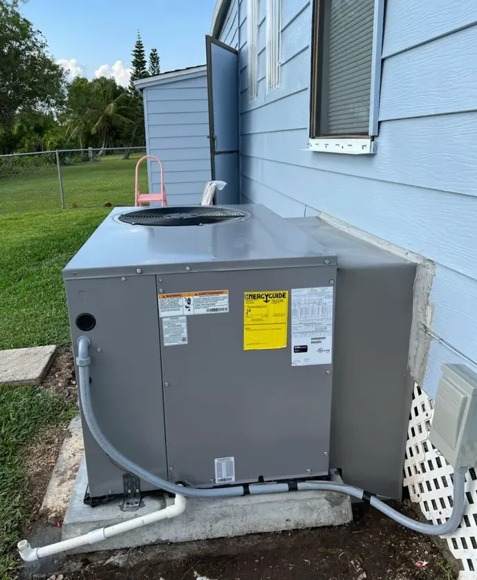 Packaged HVAC unit installed beside a manufactured home